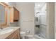 Bathroom featuring neutral tiling, a wooden vanity, and a glass enclosed shower at 1113 Hawthorne Cove Dr, Ocoee, FL 34761
