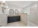 Bright bathroom featuring a double vanity, walk in shower, and neutral-toned tiling at 1113 Hawthorne Cove Dr, Ocoee, FL 34761