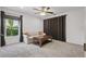 Bedroom featuring a loveseat, wood coffee table, and large window covered by curtains at 1113 Hawthorne Cove Dr, Ocoee, FL 34761