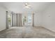 Light-filled bedroom with french doors, neutral carpet, fan, and a glimpse of a lake providing relaxation and comfort at 1113 Hawthorne Cove Dr, Ocoee, FL 34761
