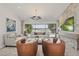 Open living room with lake views, modern chandelier, tile floors, stone fireplace, and comfortable furniture provides ample seating at 1113 Hawthorne Cove Dr, Ocoee, FL 34761