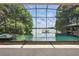 Screened in pool area featuring two swimming pools, a hot tub, and lake views at 1113 Hawthorne Cove Dr, Ocoee, FL 34761