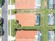 An aerial view of the back of a tile roofed home with a screened in pool at 112 Cordova Ave, Davenport, FL 33897