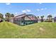 A nice backyard with green grass and a screened in pool at 112 Cordova Ave, Davenport, FL 33897