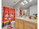 Bright bathroom with a fun Mickey Mouse-themed shower curtain and playful decor, perfect for  at 112 Cordova Ave, Davenport, FL 33897