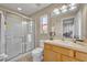Clean bathroom with a glass-enclosed shower, vanity, and bright lighting at 112 Cordova Ave, Davenport, FL 33897