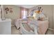 Charming bedroom with twin beds, pink linens, and whimsical decor, perfect for  at 112 Cordova Ave, Davenport, FL 33897