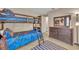 bedroom with bunk beds, dresser, and a blue and brown color scheme creating a playful atmosphere at 112 Cordova Ave, Davenport, FL 33897