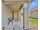 Charming front porch featuring a 'Welcome Home' sign, seating, and a view of the well-kept lawn at 112 Cordova Ave, Davenport, FL 33897