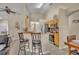 Open kitchen area with granite countertops, stainless steel appliances, and seating at the breakfast bar at 112 Cordova Ave, Davenport, FL 33897
