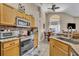Bright kitchen with granite countertops, stainless steel appliances, and a breakfast nook at 112 Cordova Ave, Davenport, FL 33897