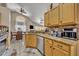 Modern kitchen with granite counters, stainless appliances, and an open layout to the dining area at 112 Cordova Ave, Davenport, FL 33897