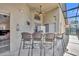 Inviting screened-in outdoor bar area with seating, ideal for entertaining guests and enjoying the serene pool view at 112 Cordova Ave, Davenport, FL 33897