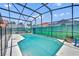 Serene screened-in pool area, offering a private retreat with comfortable lounge chairs and lush greenery, ideal for relaxation at 112 Cordova Ave, Davenport, FL 33897