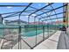 Spacious screened-in pool area with a -safety fence, featuring comfortable lounge chairs and serene privacy for relaxation at 112 Cordova Ave, Davenport, FL 33897
