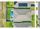 Aerial view of the property showcasing backyard patio sets, lawn, new roof, solar panels, and surrounding neighborhood at 1127 Foreshore Ln, Haines City, FL 33844