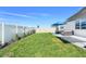 Landscaped backyard with patio, stylish seating, lush lawn, and privacy fence perfect for Gathering gatherings and enjoying the outdoors at 1127 Foreshore Ln, Haines City, FL 33844