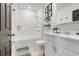 Modern bathroom featuring white tiles, a glass shower door, and contemporary fixtures at 1127 Foreshore Ln, Haines City, FL 33844