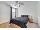 Cozy bedroom features a ceiling fan, a window with blinds, and a comfortable bed at 1127 Foreshore Ln, Haines City, FL 33844