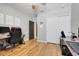 Office with a large closet, modern desk, and hardwood floors at 1127 Foreshore Ln, Haines City, FL 33844