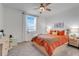 Bright bedroom featuring a window, ceiling fan, modern furniture, and comfortable bedding at 1127 Foreshore Ln, Haines City, FL 33844