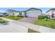 Lovely single Gathering home with manicured lawn, brick driveway, and an attached garage at 1127 Foreshore Ln, Haines City, FL 33844