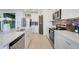Modern kitchen featuring white cabinets, stainless steel appliances, and a stylish backsplash at 1127 Foreshore Ln, Haines City, FL 33844