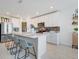 Bright kitchen features an island with seating, stainless steel appliances, and white cabinets at 1127 Foreshore Ln, Haines City, FL 33844