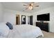 Comfortable bedroom with neutral decor, a ceiling fan, and a large window for natural light at 1127 Foreshore Ln, Haines City, FL 33844