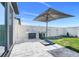 Backyard patio with built-in grill, gray brick pavers and new fence create a serene spot for outdoor cooking at 1127 Foreshore Ln, Haines City, FL 33844