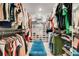 Spacious walk-in closet with ample shelving, hanging space, and a central bench for convenience at 1127 Foreshore Ln, Haines City, FL 33844