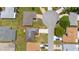 Aerial view of a charming home with a well-manicured lawn and mature trees at 11811 Scarecrow Ln, Orlando, FL 32821