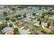 A high aerial view of the property in its neighborhood, near a pond at 11811 Scarecrow Ln, Orlando, FL 32821