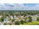 A high aerial view of the property in its neighborhood, near a lake at 11811 Scarecrow Ln, Orlando, FL 32821