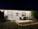 View of backyard patio with chairs and string lights at night at 11811 Scarecrow Ln, Orlando, FL 32821