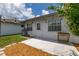 View of backyard patio with wood flooring, leading to the white door of the home at 11811 Scarecrow Ln, Orlando, FL 32821