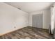 This is a spacious bedroom featuring wooden-look flooring, a window, and a closet with folding doors at 11811 Scarecrow Ln, Orlando, FL 32821
