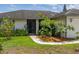 Inviting front yard with lush landscaping that frames the entryway at 11811 Scarecrow Ln, Orlando, FL 32821