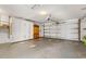 Spacious garage with ample storage cabinets and roll-up doors, providing plenty of room for vehicles at 11811 Scarecrow Ln, Orlando, FL 32821
