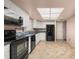 Modern kitchen with tiled flooring, featuring sleek appliances and a bright interior at 11811 Scarecrow Ln, Orlando, FL 32821