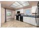 Bright kitchen with white cabinets, black appliances, and tiled floor at 11811 Scarecrow Ln, Orlando, FL 32821