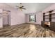 Spacious living room featuring ceiling fan and view to the backyard at 11811 Scarecrow Ln, Orlando, FL 32821