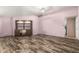 Open living room with wood laminate flooring and built-in shelving unit at 11811 Scarecrow Ln, Orlando, FL 32821