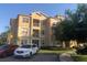 Well maintained tan building with balconies, manicured landscaping, and parking at 120 Terrace Ridge Cir # 120, Davenport, FL 33896