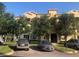 Well maintained tan building with mature landscaping, and parking at 120 Terrace Ridge Cir # 120, Davenport, FL 33896