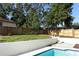 Spacious backyard with a pool, lush grass, and a well-maintained wooden fence at 1204 Duncan Ct, Longwood, FL 32779