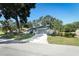 Single-story home with a gray roof, well-manicured lawn, and a paved driveway at 1204 Duncan Ct, Longwood, FL 32779