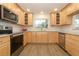 Modern kitchen with stainless steel appliances, subway tile backsplash and light wood cabinets at 1204 Duncan Ct, Longwood, FL 32779
