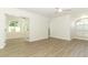 Sunlit living room with light wood flooring and view into the Florida room at 1204 Duncan Ct, Longwood, FL 32779
