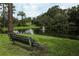 Scenic park view with a bench overlooking a tranquil pond with a fountain at 1204 Duncan Ct, Longwood, FL 32779